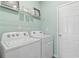 Clean laundry room with shelving, washer, and dryer at 300 Shine Dr, Stockbridge, GA 30281