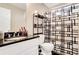 This bathroom features a white vanity with a black countertop and a shower with a black and white curtain at 3337 Camens Way, Buford, GA 30519