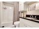 This bathroom features a white vanity with a black countertop, shower and toiletry storage at 3337 Camens Way, Buford, GA 30519