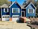Two-car garage, brick accents, and a well-maintained lawn add to the home's inviting exterior at 3337 Camens Way, Buford, GA 30519