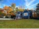 Charming blue home with white trim, mature trees, and well-manicured lawn, offering great curb appeal at 3337 Camens Way, Buford, GA 30519