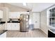 Bright kitchen has stainless steel appliances, and white cabinets at 3337 Camens Way, Buford, GA 30519