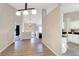 Open concept living area flows into kitchen, featuring wood floors and neutral paint at 3337 Camens Way, Buford, GA 30519