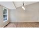 Spacious living room with vaulted ceiling, wood floors, and large window at 3337 Camens Way, Buford, GA 30519