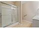 Clean bathroom showcasing a glass door shower and tiled floor at 460 Tribble Gap Rd # 1004, Cumming, GA 30040