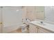 All white bathroom with tiled floors, a shower-tub, and a single vanity at 460 Tribble Gap Rd # 1004, Cumming, GA 30040