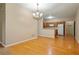 Open concept dining area featuring hardwood floors and a kitchen view at 460 Tribble Gap Rd # 1004, Cumming, GA 30040