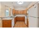 Well-lit kitchen featuring wood cabinets, white countertop, and a refrigerator at 460 Tribble Gap Rd # 1004, Cumming, GA 30040