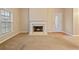 Warm living room featuring a fireplace, wall to wall carpet and a large window at 460 Tribble Gap Rd # 1004, Cumming, GA 30040