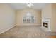 Spacious living room with cozy fireplace and carpet, illuminated by natural light from large windows at 460 Tribble Gap Rd # 1004, Cumming, GA 30040