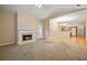 Open-concept living area with fireplace, carpet flooring, and seamless flow to the bright kitchen at 460 Tribble Gap Rd # 1004, Cumming, GA 30040