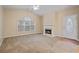 Bright living room with fireplace, ceiling fan, oval door glass, and large window at 460 Tribble Gap Rd # 1004, Cumming, GA 30040