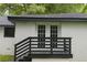 View of the backyard with a porch and door with grids, dark railing at 1956 Shirley Sw St, Atlanta, GA 30311