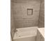 Updated bathroom with tub and tiled shower with a built-in niche at 1956 Shirley Sw St, Atlanta, GA 30311