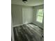 Bedroom featuring new flooring, fresh paint, closet, and a view to the backyard at 1956 Shirley Sw St, Atlanta, GA 30311