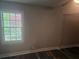 Bedroom featuring dark floors, neutral walls, a window looking out at the home's exterior, and a modern ceiling fan at 1956 Shirley Sw St, Atlanta, GA 30311