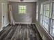 Bright bedroom with new flooring, large windows, and freshly painted walls at 1956 Shirley Sw St, Atlanta, GA 30311