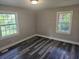 Bedroom featuring two windows and wood-look flooring at 1956 Shirley Sw St, Atlanta, GA 30311