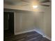 Bedroom featuring new dark floors, neutral walls, a modern ceiling fan, and a doorway to another room at 1956 Shirley Sw St, Atlanta, GA 30311