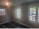 Bedroom with neutral paint, dark hardwood flooring, and plenty of natural light from the large windows at 1956 Shirley Sw St, Atlanta, GA 30311