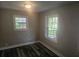 Bedroom with neutral paint, dark hardwood flooring, and plenty of natural light from the large windows at 1956 Shirley Sw St, Atlanta, GA 30311