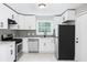 Modern kitchen featuring white cabinets, stainless steel appliances, and tile backsplash at 1956 Shirley Sw St, Atlanta, GA 30311