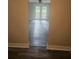 View through doorway into bright living room with doors to back patio and ceiling fan at 1956 Shirley Sw St, Atlanta, GA 30311