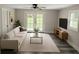 Bright living room with hardwood floors, a modern sofa, and access to the backyard at 1956 Shirley Sw St, Atlanta, GA 30311
