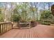 Wooden deck with mature landscape and wooden railings at 3595 Limberlost Sw Trl, Stockbridge, GA 30281