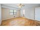 Bedroom with hardwood floors, natural light from window, and an attached bathroom view at 3595 Limberlost Sw Trl, Stockbridge, GA 30281