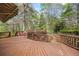 Spacious wooden deck overlooking a lush, fenced backyard with mature trees at 3595 Limberlost Sw Trl, Stockbridge, GA 30281