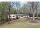Traditional home with a well-manicured lawn and mature trees at 3595 Limberlost Sw Trl, Stockbridge, GA 30281
