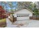 Attached two-car garage with a driveway at 3595 Limberlost Sw Trl, Stockbridge, GA 30281
