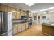 The kitchen features stainless steel appliances, wooden cabinets, granite countertops, and tile backsplash at 3595 Limberlost Sw Trl, Stockbridge, GA 30281