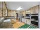 The kitchen features stainless steel appliances, wooden cabinets, granite countertops, and tile backsplash at 3595 Limberlost Sw Trl, Stockbridge, GA 30281