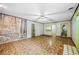 Large living room boasts retro paneling, unique flooring, a ceiling fan, and nature-themed decor at 3595 Limberlost Sw Trl, Stockbridge, GA 30281