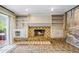 Living area with a brick fireplace, custom built-ins, and sliding glass doors leading to the backyard at 3595 Limberlost Sw Trl, Stockbridge, GA 30281