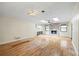 Open living room with a stone fireplace, hardwood floors, skylights, and natural light at 3595 Limberlost Sw Trl, Stockbridge, GA 30281