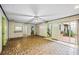 Open living room with a fan, unique flooring, and access to a courtyard through sliding glass doors at 3595 Limberlost Sw Trl, Stockbridge, GA 30281