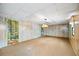 Spacious living room features unique wood paneling and a nature mural for a rustic feel at 3595 Limberlost Sw Trl, Stockbridge, GA 30281