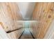 Staircase featuring carpeted steps, a wood-paneled walls, and a simple railing at 3595 Limberlost Sw Trl, Stockbridge, GA 30281