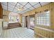 Unique sunroom with tile floor, glass block window, ceiling fan, and door leading to a deck at 3595 Limberlost Sw Trl, Stockbridge, GA 30281