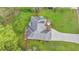 High-angle view of a home featuring a deck with seating, paved driveway, and well-maintained green lawn at 4995 Hyde Ct, Cumming, GA 30040