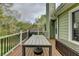 A lovely outdoor area to relax or entertain guests on this home's back deck with seating and wooded view at 4995 Hyde Ct, Cumming, GA 30040