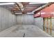 Unfinished basement with visible ceiling fixtures, concrete walls, and storage cabinets offering potential for customization at 4995 Hyde Ct, Cumming, GA 30040