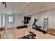 Basement area with exercise equipment, open layout, and a walkout door at 4995 Hyde Ct, Cumming, GA 30040