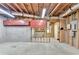 Spacious unfinished basement with exposed ceiling beams, red storage cabinets, and framed walls, ready for personalization at 4995 Hyde Ct, Cumming, GA 30040