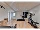 Spacious basement featuring exercise equipment and wood flooring at 4995 Hyde Ct, Cumming, GA 30040