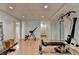 Open basement area with exercise equipment and access to other rooms at 4995 Hyde Ct, Cumming, GA 30040