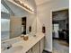 Bright bathroom featuring double sinks, modern fixtures, and a view into the main bedroom at 4995 Hyde Ct, Cumming, GA 30040